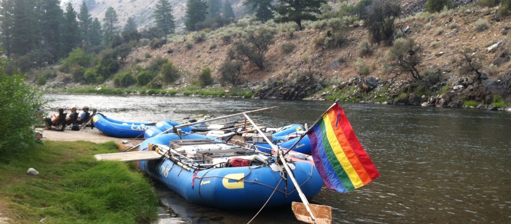 lgbtq rafting with rainbow flag